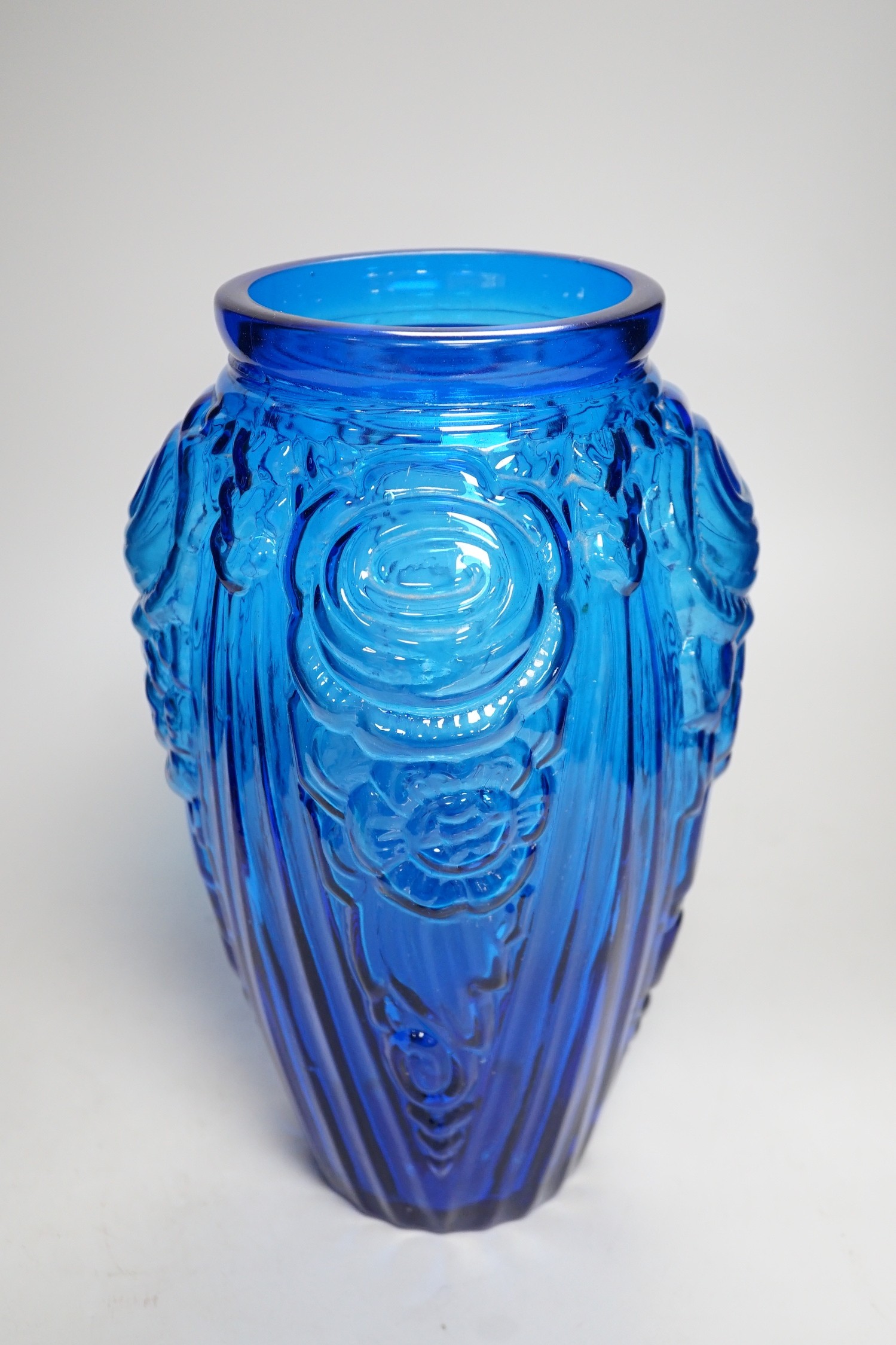 An Art Deco blue floral moulded glass vase. 31cm tall